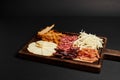 charcuterie board with cheese selection, dried