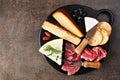 Charcuterie board overhead view on a dark background