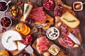 Charcuterie boards of assorted cheeses, meats and appetizers, above view table scene on rustic wood Royalty Free Stock Photo