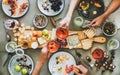 Charcuterie and cheese board, rose wine, snacks and peoples hands