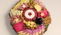 Charcuterie and cheese platter rotates smoothly around its axis. Appetizers boards with assorted cheese, salami, ham, olives and