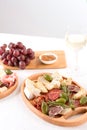 Charcuterie plate with different types of meat snacks - salami, bresaola, proscuitto. Plates with traditional italian antipasti