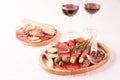 Charcuterie plate with different types of meat snacks. Wooden plates with traditional italian antipasti