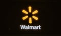 Chardon, Ohio, USA - 2-11-22: A litup fluorescent Walmart sign on a brick wall at night