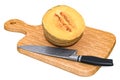 Charentais melon lies on a wooden board next to a knife, 3D rendering Royalty Free Stock Photo