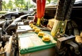 Charge the battery for start engine in engine room of old car Royalty Free Stock Photo