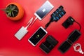 Charge a variety of mobile devices. Flat lay on a red background.