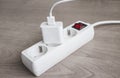 Charger adapter with USB cable connected to Power Strip with red switch Royalty Free Stock Photo