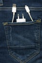 Charger in jeans pocket. Mobile USB and electric plug