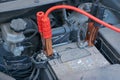 Charging automobile battery with another car jumper cables at winter