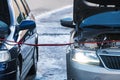 Charging a car battery in winter. Help on the road. Close-up. Connecting high voltage wires to the car battery. Resuscitation of Royalty Free Stock Photo