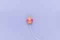 Charging Easter egg with cable. Loading simple background Royalty Free Stock Photo