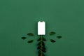 Charging Eco energy or green power illustration with a white battery and sprigs leaves on a green background with copy space for Royalty Free Stock Photo