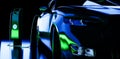 Charging an electric car with a charger, abstract neon lighting. Sustainable climate visuals