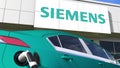 Charging electric car plug and SIEMENS logo. Editorial conceptual 3d 3d rendering