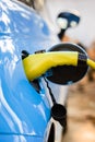 Charging electric car with power cable supply plugged in Royalty Free Stock Photo