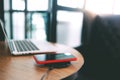 Charging mobile phone battery with wireless charging device in the table. Smartphone charging on a charging pad. Mobile phone near Royalty Free Stock Photo