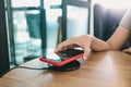 Charging mobile phone battery with wireless charging device in the table. Smartphone charging on a charging pad. Mobile phone near Royalty Free Stock Photo