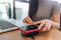 Charging mobile phone battery with wireless charging device in the table. Smartphone charging on a charging pad. Mobile phone near Royalty Free Stock Photo