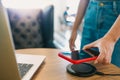 Charging mobile phone battery with wireless device in the table. Smartphone charging on a charging pad. Mobile phone near wireless Royalty Free Stock Photo