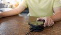 Charging mobile phone battery with wireless device in the table. Smartphone charging on a charging pad. Mobile phone near wireless Royalty Free Stock Photo