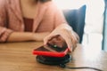 Charging mobile phone battery with wireless charging device in the table. Smartphone charging on a charging pad. Mobile phone near Royalty Free Stock Photo