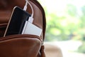 Charging mobile phone with power bank in backpack, closeup. Space for text Royalty Free Stock Photo