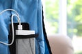 Charging mobile phone with power bank in light blue backpack, closeup. Space for text Royalty Free Stock Photo