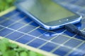 Charging mobile phone with solar charger Royalty Free Stock Photo