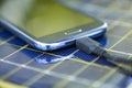 Charging mobile phone with solar charger Royalty Free Stock Photo