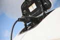 Charging modern electric car battery on the street which are the future of the Automobile, Close up of power supply plugged into Royalty Free Stock Photo