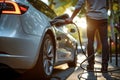 charging modern electric car battery on the street which are the future of the Automobile, Close up of power supply plugged into Royalty Free Stock Photo