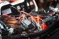 Charging motorcycle battery at garage, selective focus on Alligator clip ,concept of motorcycle maintenance and repair
