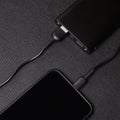 Charging power bank. Portable powerbank with white usb cable for charger mobile phone or smartphone battery. Modern technology Royalty Free Stock Photo