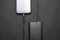 Charging power bank. Portable powerbank with white usb cable for charger mobile phone or smartphone battery. Modern technology Royalty Free Stock Photo