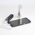 Charging a smartphone from powerbank on white Royalty Free Stock Photo