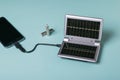 Charging the smartphone from a source of electrical energy powered by the sun. Use of solar energy