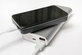 Charging smartphone from white powerbank Royalty Free Stock Photo