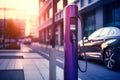 Charging station for recharging the battery with electricity using an EV charging cable in an evening city street. Innovative