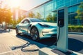 charging a steel-colored electric car at a power plant in the city center. Beautiful unfocused background of the city