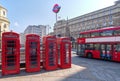Charing cross with three icons in one photo. Red Bus, Underground sign and Telephone Box.