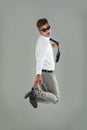 Charisma and energy. Portrait of a young man looking back while jumping in the air. Royalty Free Stock Photo
