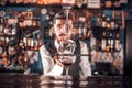 Experienced bartender adds ingredients to a cocktail in cocktail bars