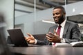 Charismatic black manager having business conference, using laptop Royalty Free Stock Photo