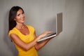 Charismatic female holding laptop while smiling