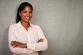 Charismatic female smiling with arms crossed