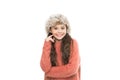Charismatic kid girl wear hat with ear flaps white background. Soft furry accessory. Caring fur garments. Child long