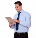 Charismatic latin guy using his tablet pc