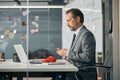 Charismatic man learning crocket hook in the office