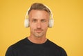 charismatic man wearing earphones. concept of music and digital technology. ebook and elearning. mature unshaven guy in